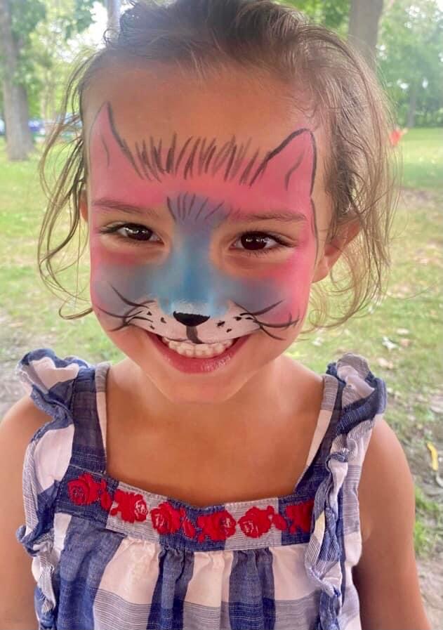 Colorful cat face painting design created by Laughing Llama for a Wisconsin event.