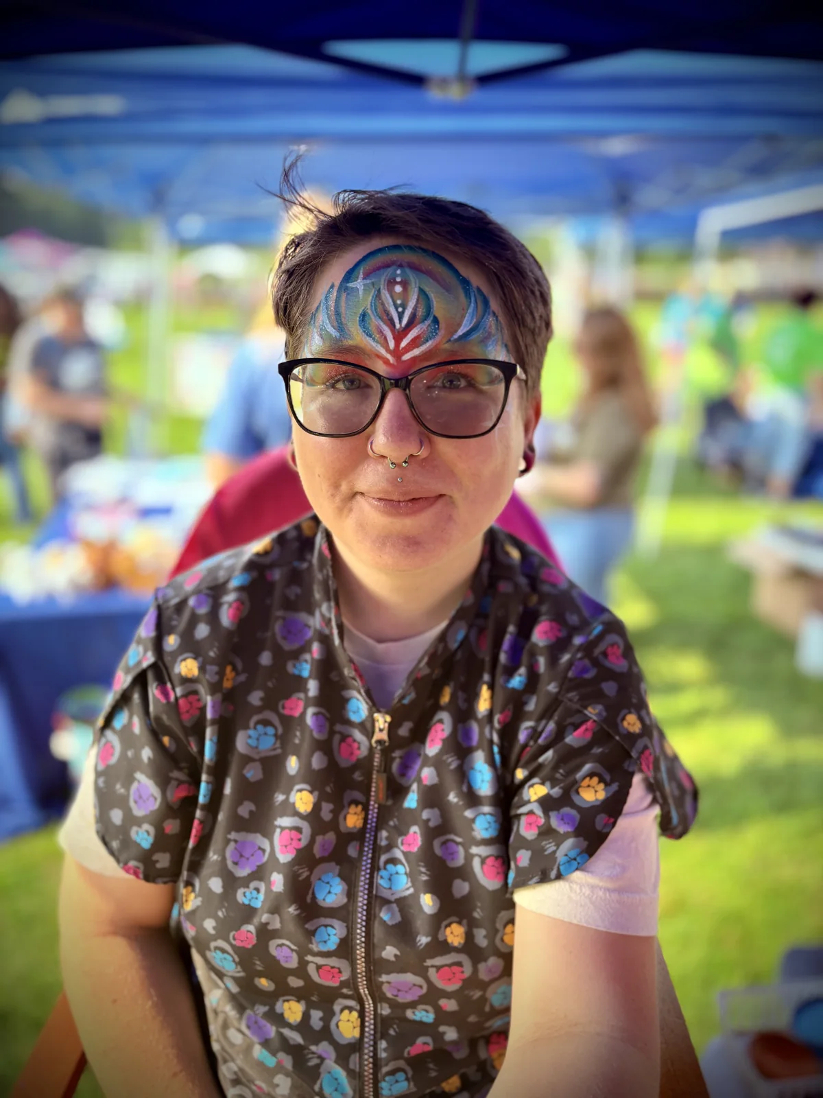 Rainbow pride face painting by Laughing Llama at a Southeastern Wisconsin event.